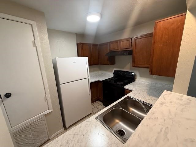22211 Moss Falls Lane Spring, TX 77373 - Photo 6 of 12 a kitchen with a refrigerator and a sink