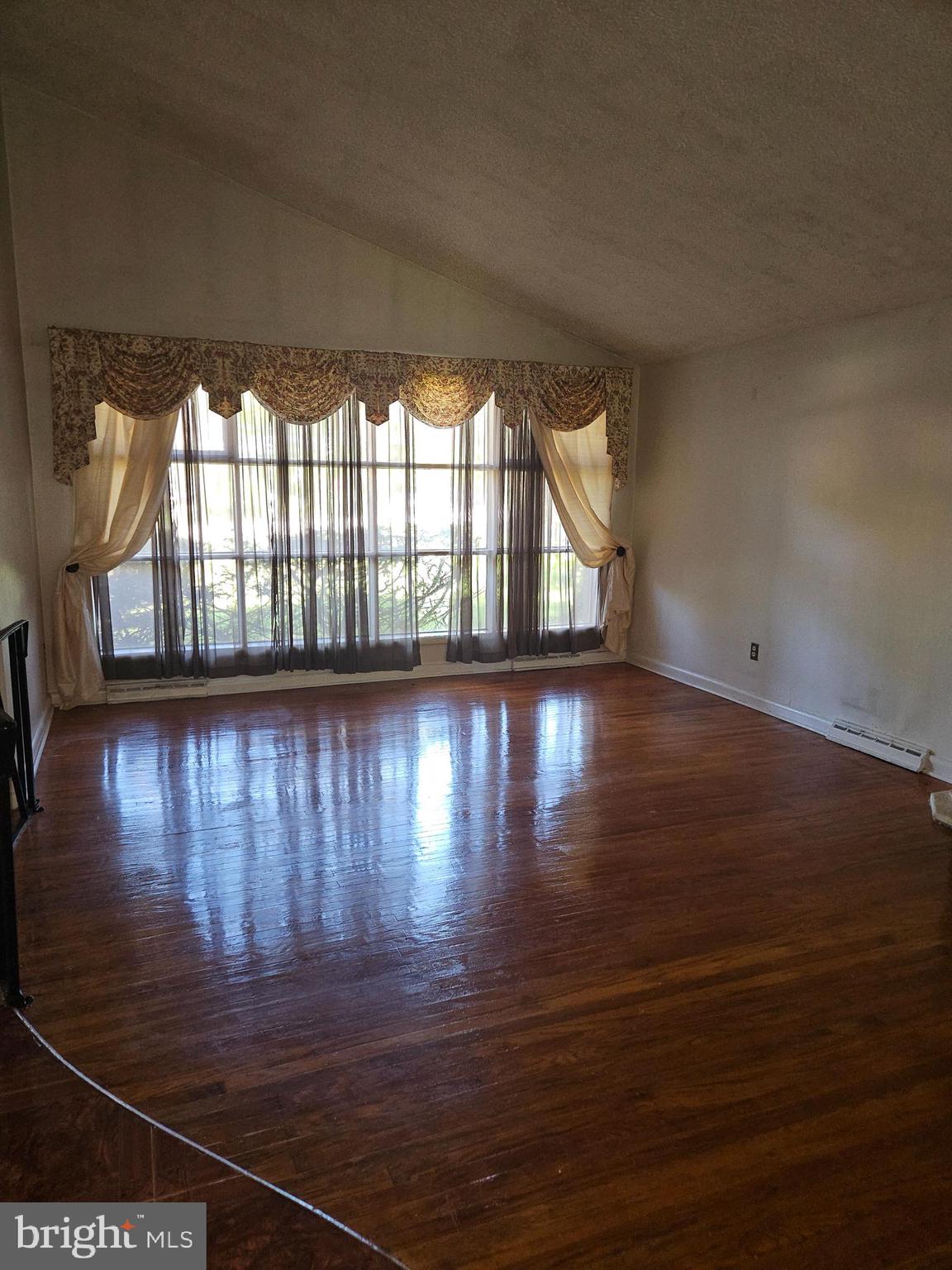 148 Church Road Elkins Park, PA 19027 - Photo 7 of 33 a view of an empty room with wooden floor and a window