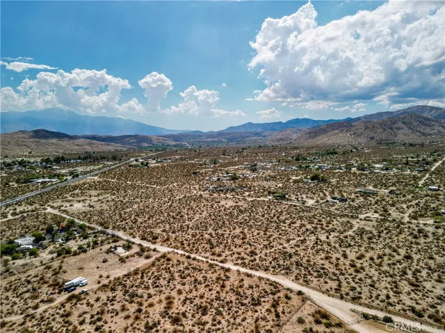 an aerial view of houses with sky view