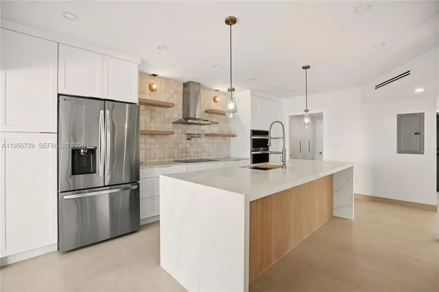 a kitchen with stainless steel appliances refrigerator and microwave