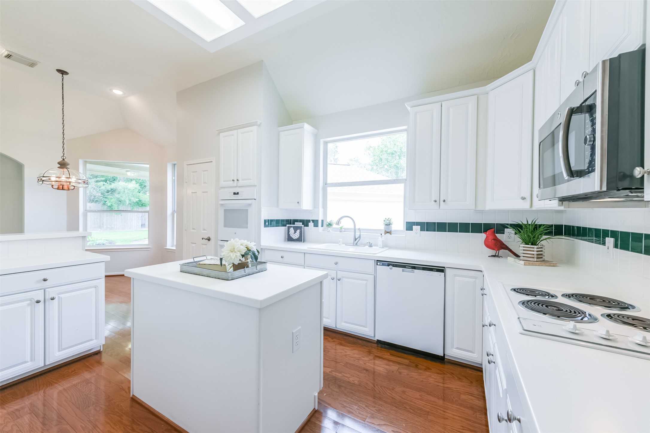 14610 Farrawood Drive Cypress, TX 77429 - Photo 11 of 35 a kitchen with white cabinets sink and white appliances