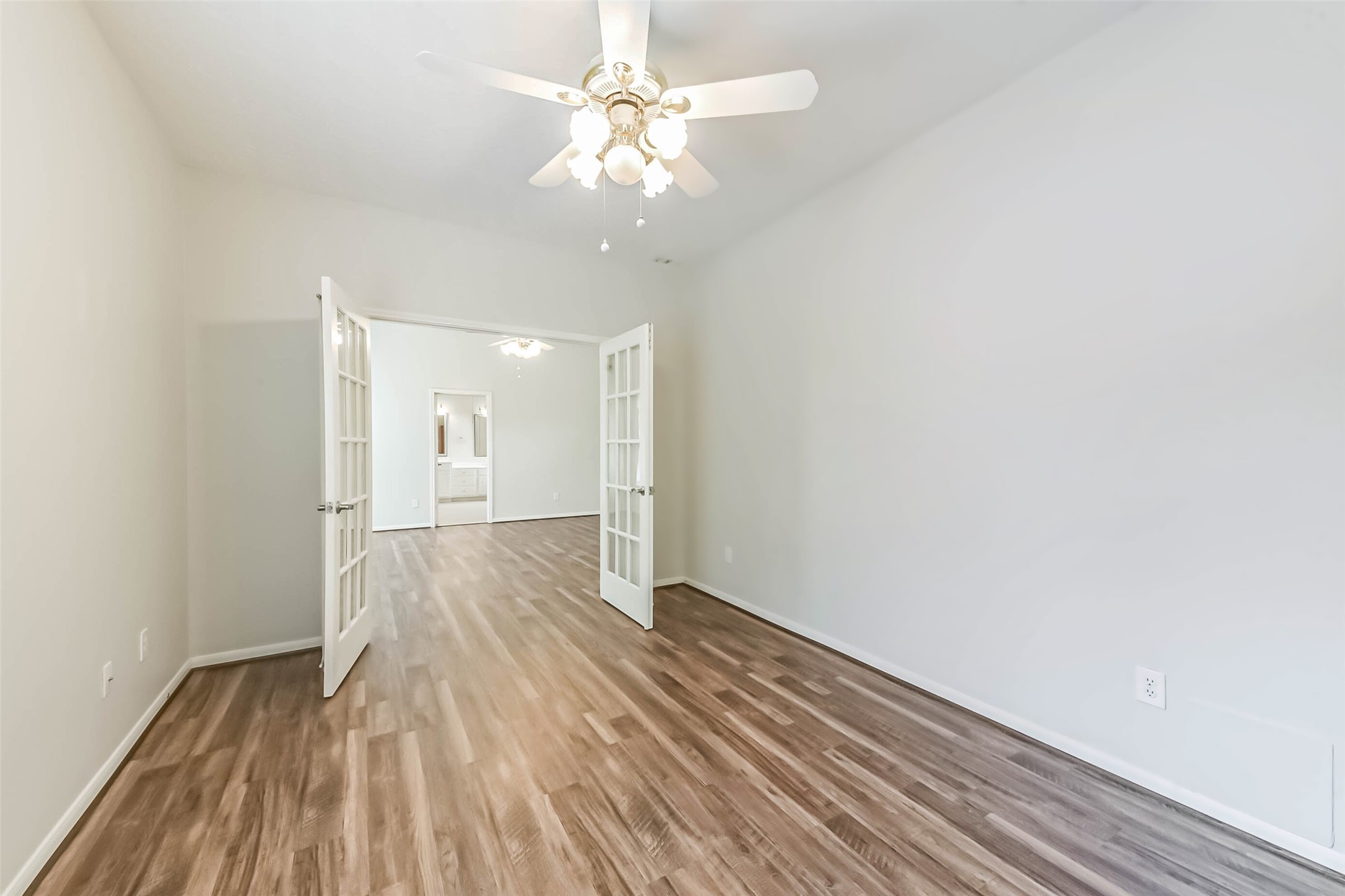 14610 Farrawood Drive Cypress, TX 77429 - Photo 25 of 35 a view of an empty room with wooden floor