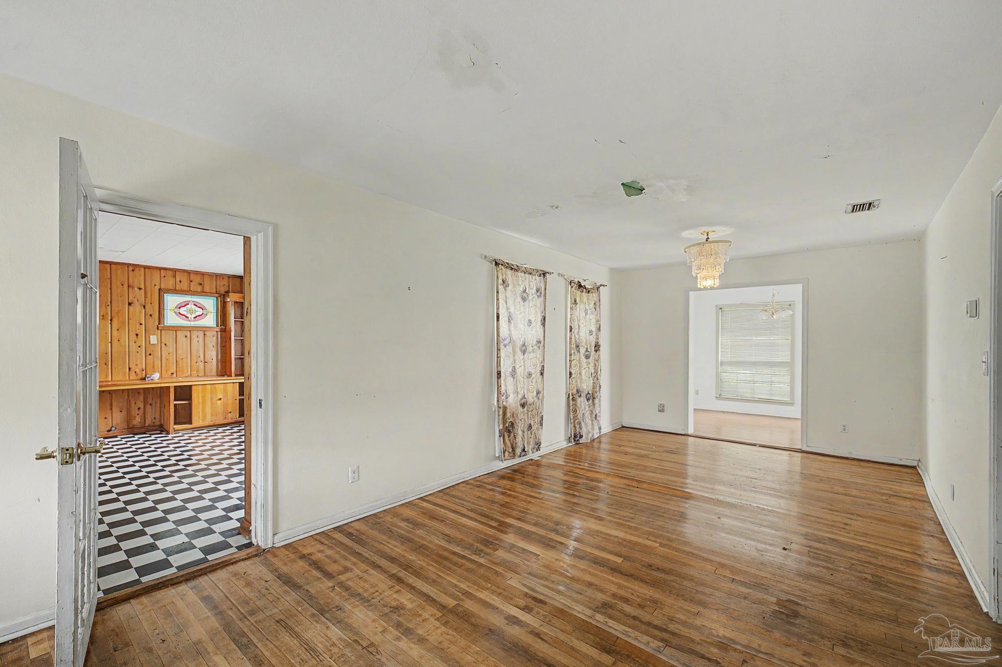 333 Gibbs Road Pensacola, FL 32507 - Photo 4 of 34 a view of an empty room with wooden floor and a window