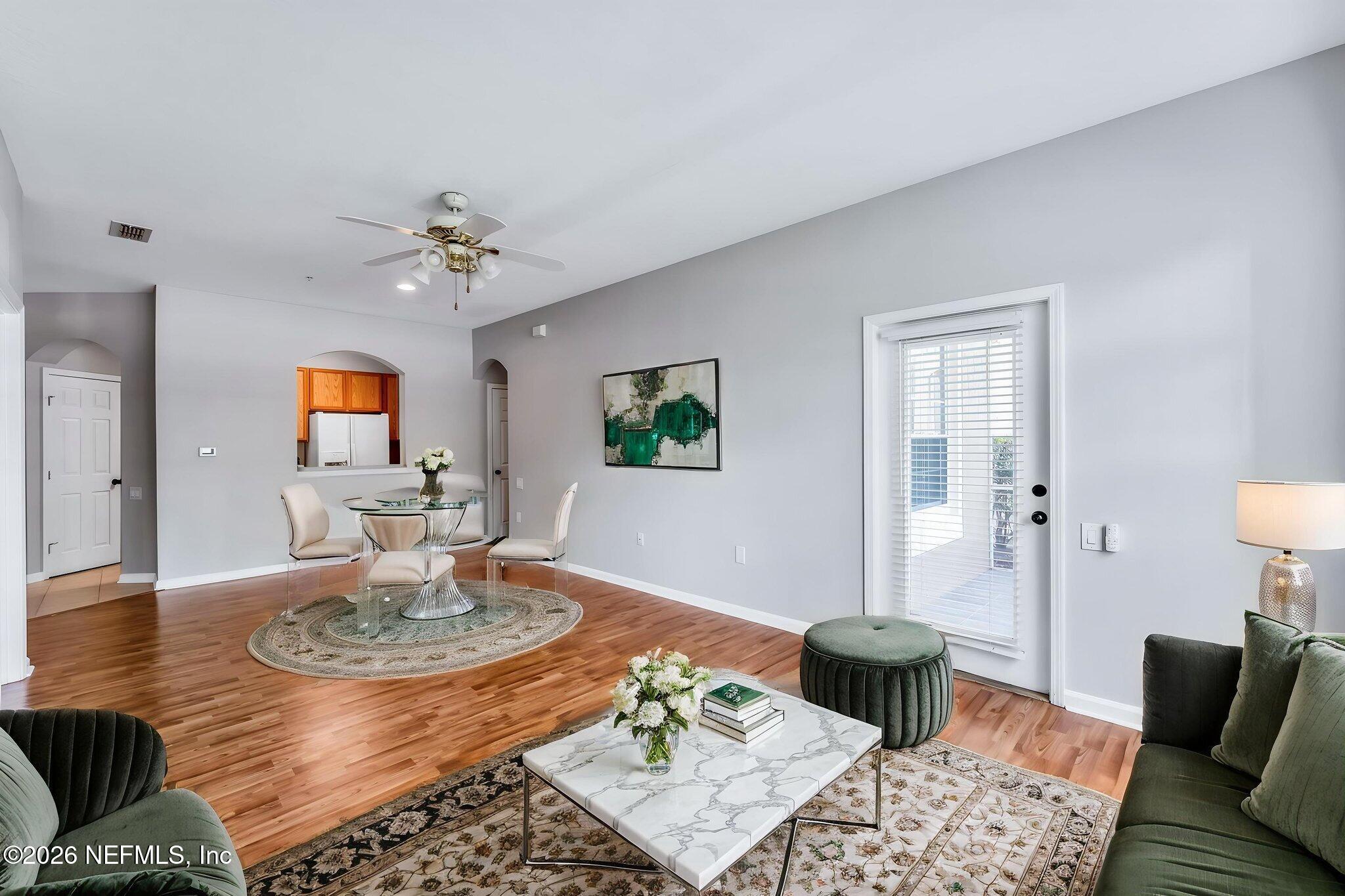 7990 Baymeadows Road East, Unit 520 Jacksonville, FL 32256 - Photo 15 of 41 a living room with furniture and wooden floor