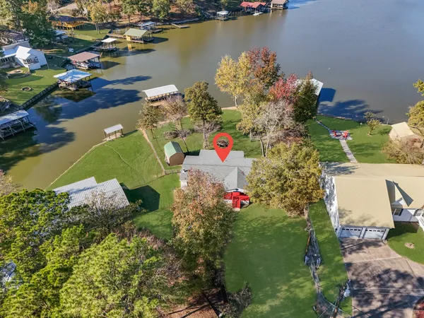 an aerial view of a houses with swimming pool
