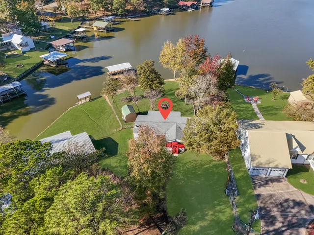 an aerial view of a houses with swimming pool
