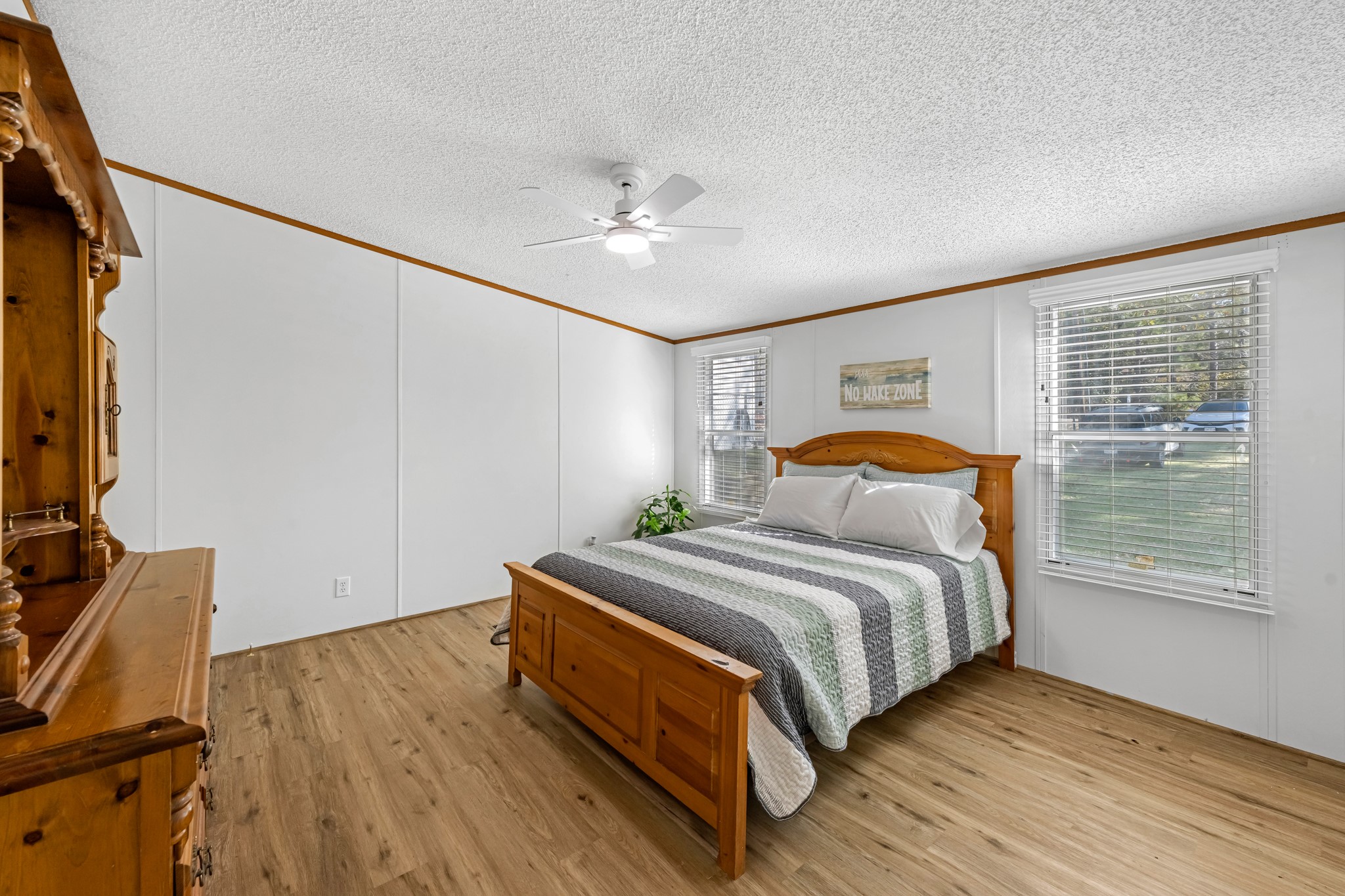 450 Ridge Trail Trinity, TX 75862 - Photo 11 of 30 a bedroom with a bed and a flat tv screen on dresser