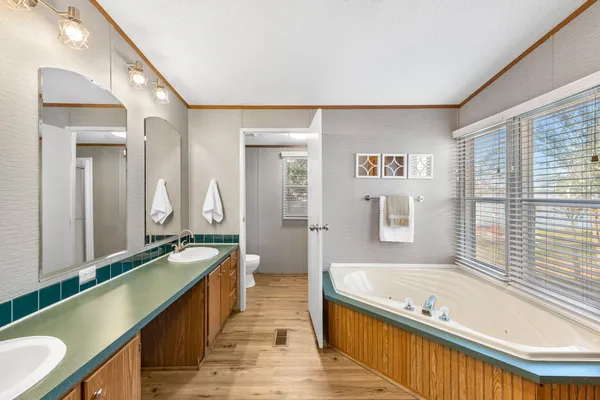 a large spacious bathroom with a large tub and sink