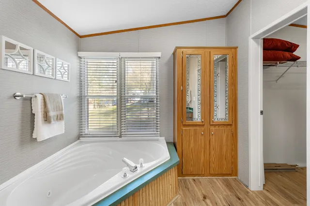 a bathroom with a tub and a window