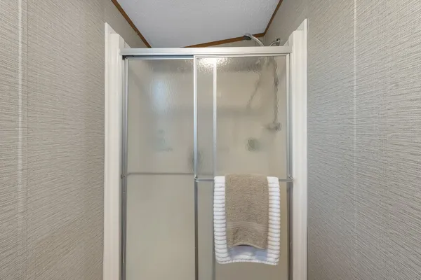 a bathroom with a glass shower door