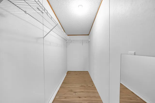 a view of a hallway with wooden floor and entryway