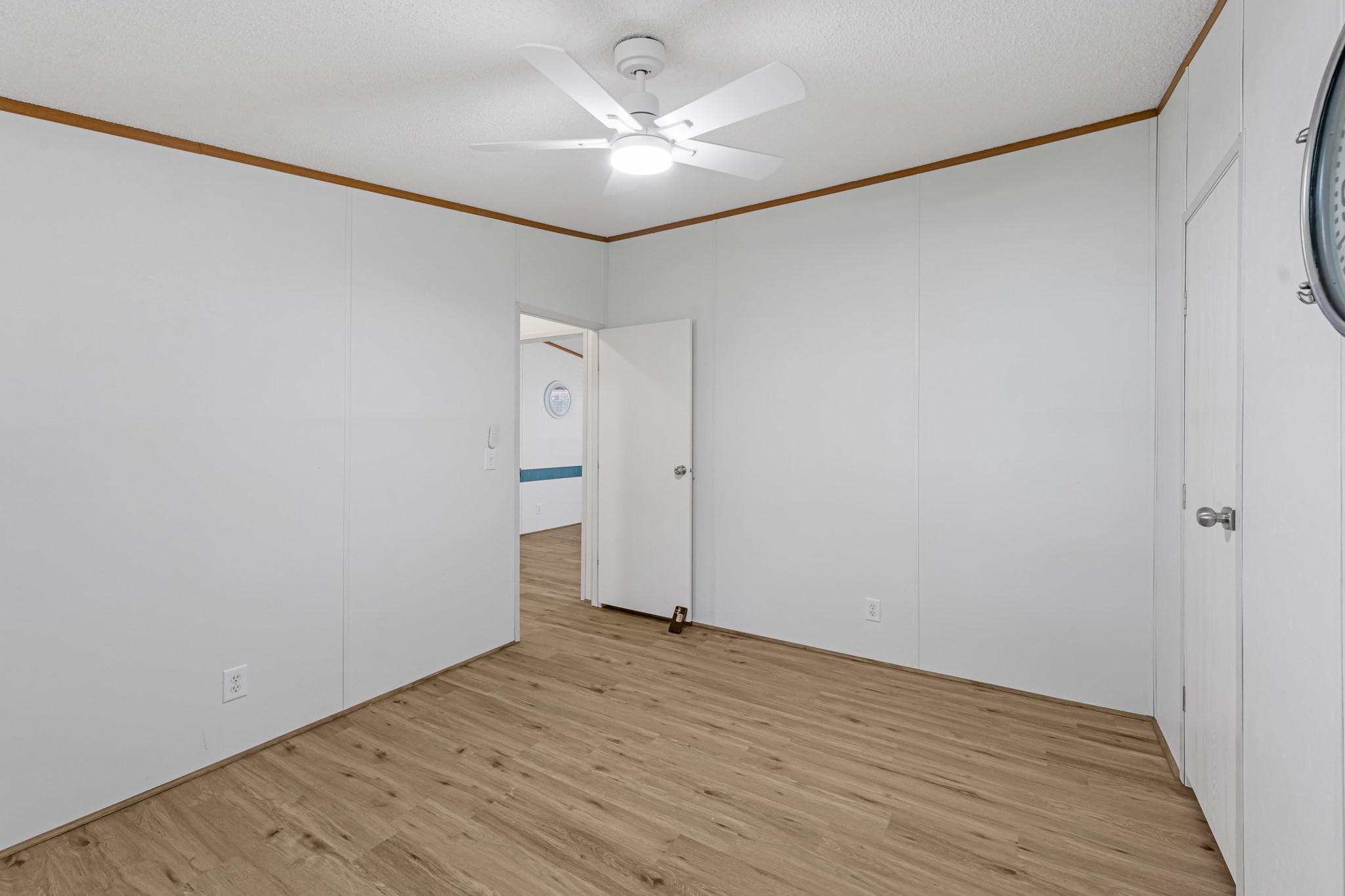450 Ridge Trail Trinity, TX 75862 - Photo 22 of 30 an empty room with wooden floor and a ceiling fan