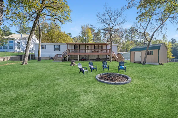 a backyard of a house with lots of green space and fountain