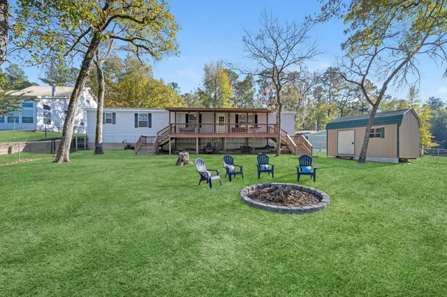 a backyard of a house with lots of green space and fountain
