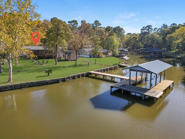 an aerial view of a house with swimming pool patio and outdoor seating