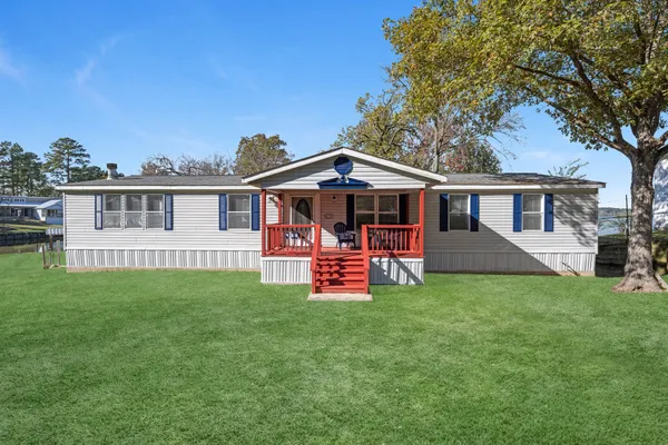 a view of a house with a yard porch and sitting area