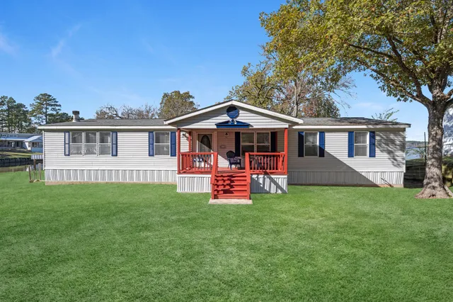 a view of a house with a yard porch and sitting area