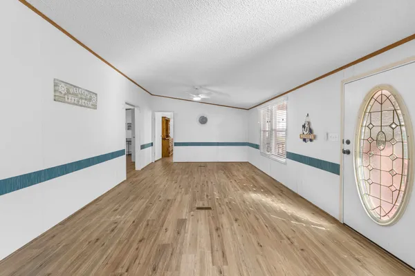 a view of empty room with wooden floor