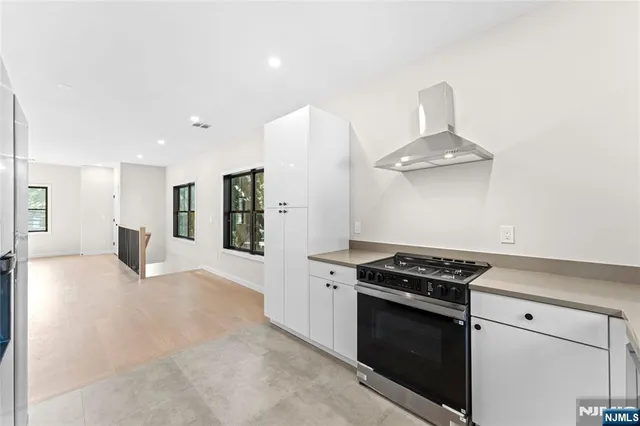 a kitchen with stainless steel appliances a stove and a refrigerator