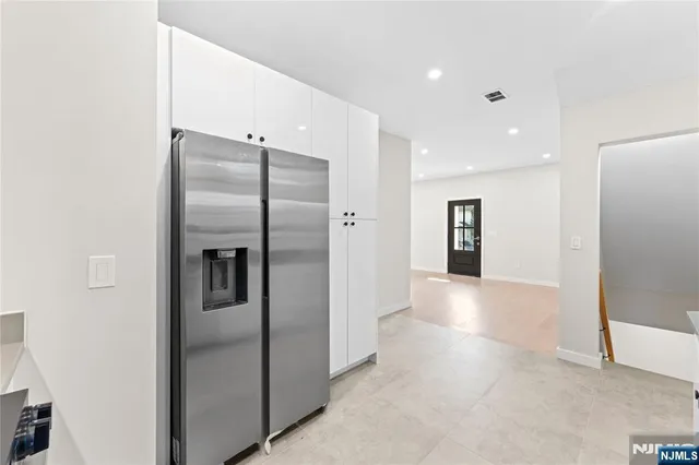 a view of a refrigerator in kitchen and a sink