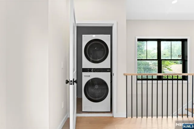 a view of a small space with washing machine and a large window