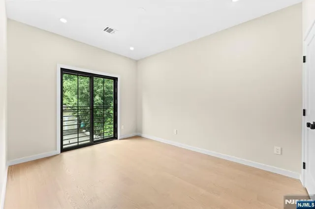 an empty room with large windows