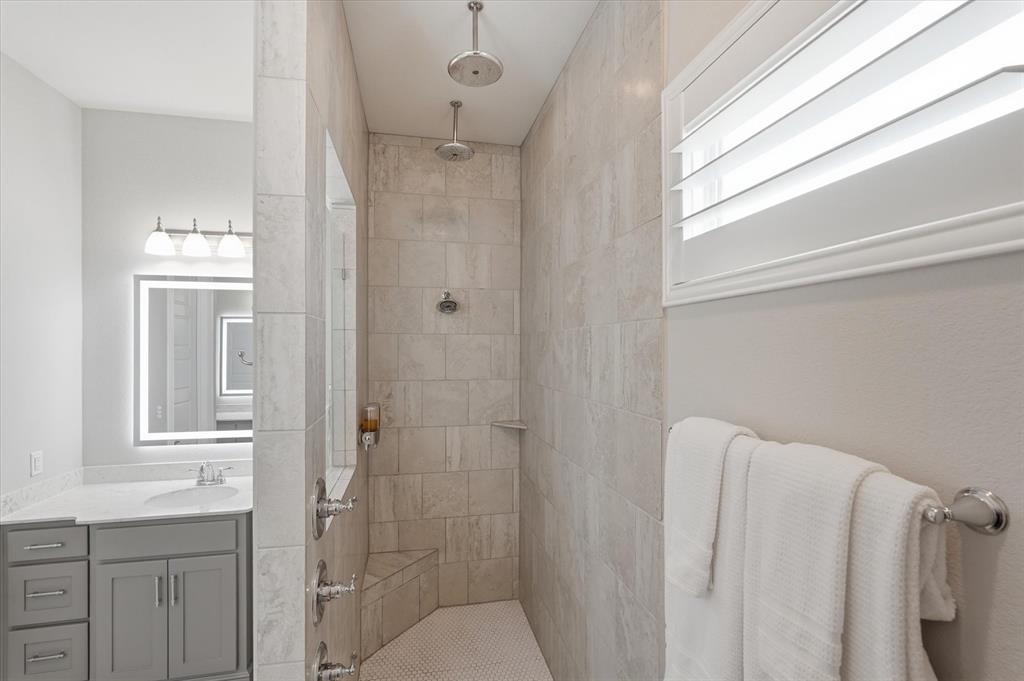 8713 Homestead Boulevard Rowlett, TX 75089 - Photo 13 of 28 a bathroom with a shower and a sink