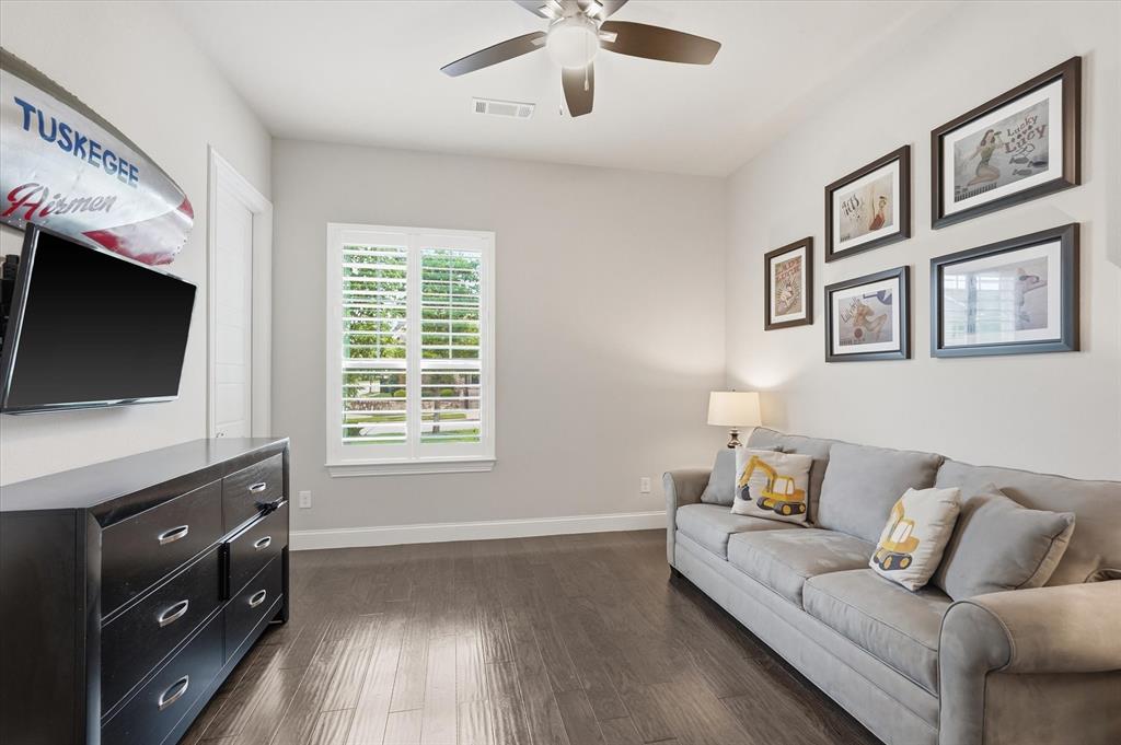 8713 Homestead Boulevard Rowlett, TX 75089 - Photo 18 of 28 a living room with furniture and a flat screen tv