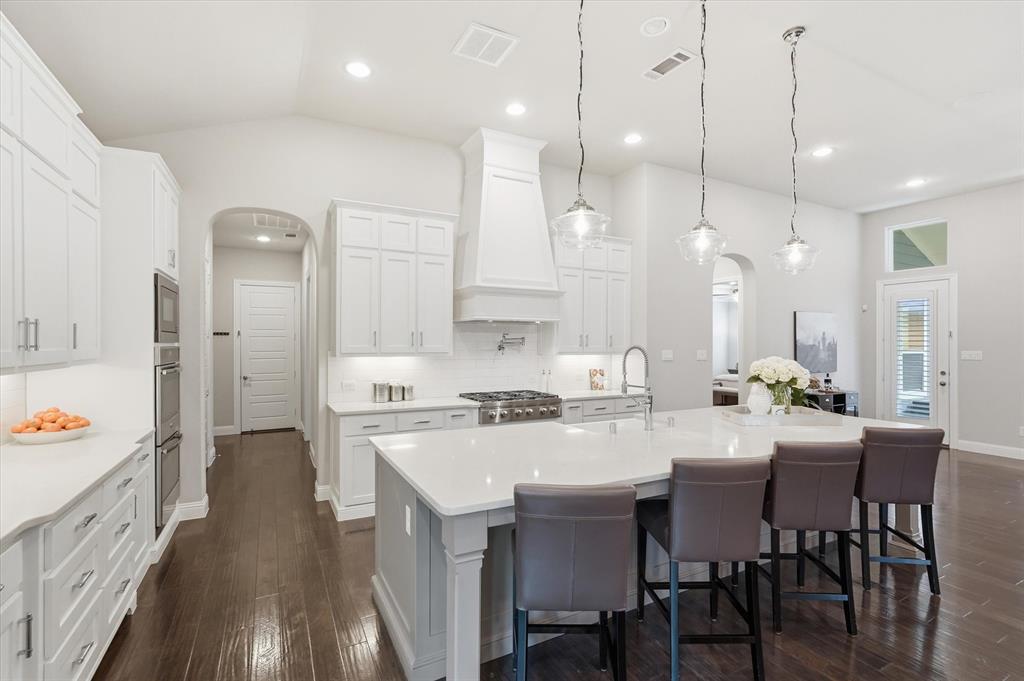 8713 Homestead Boulevard Rowlett, TX 75089 - Photo 3 of 28 a large kitchen with a table and chairs