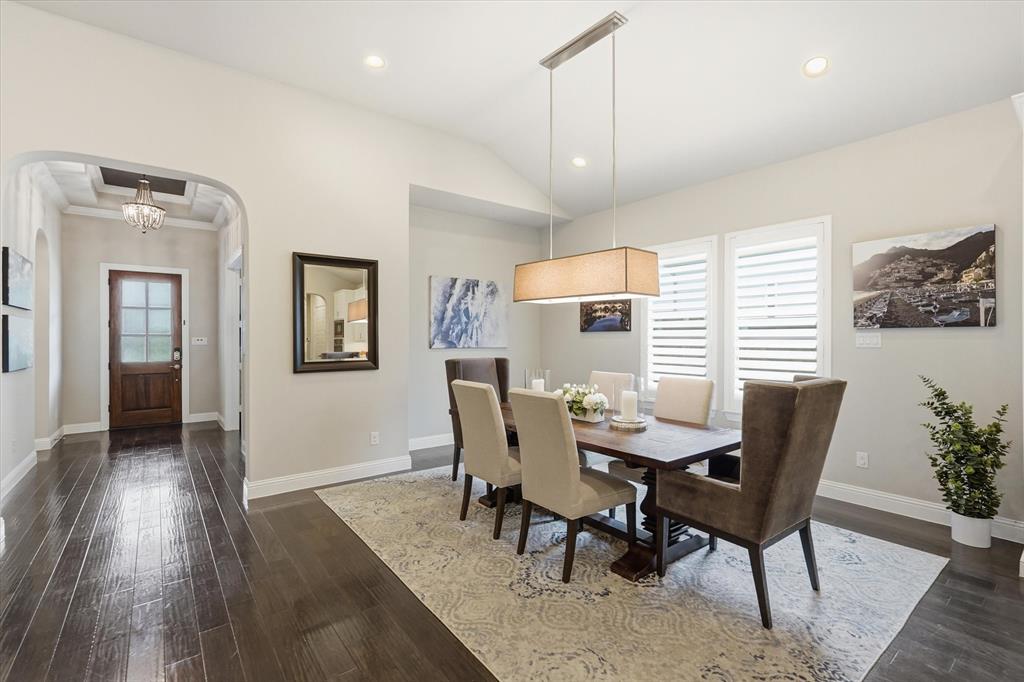 8713 Homestead Boulevard Rowlett, TX 75089 - Photo 7 of 28 a view of a dining room with furniture and wooden floor