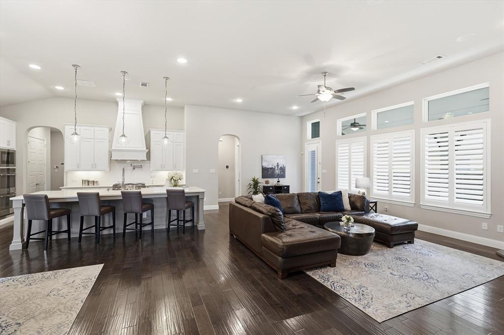8713 Homestead Boulevard Rowlett, TX 75089 - Photo 8 of 28 a living room with furniture kitchen view and a wooden floor