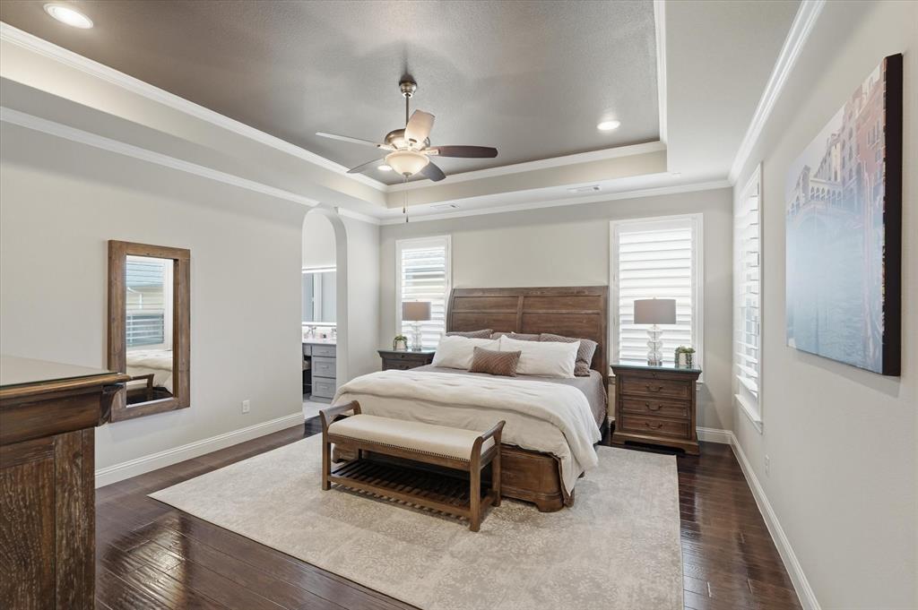8713 Homestead Boulevard Rowlett, TX 75089 - Photo 10 of 28 a bedroom with a bed and a chandelier