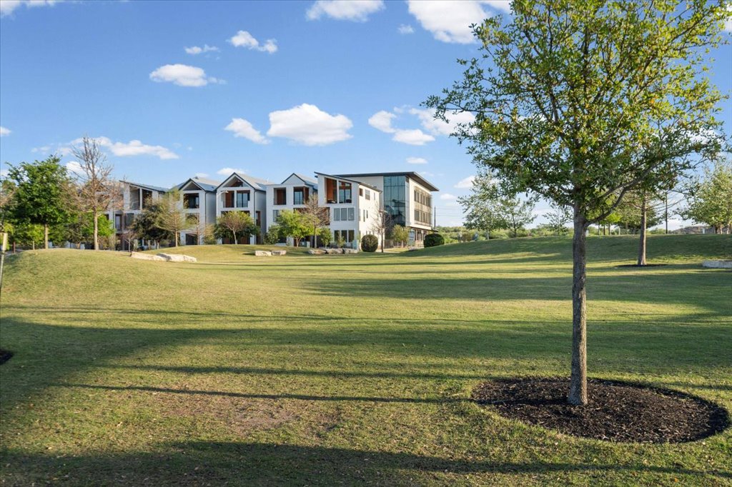 9015 Cattle Baron Path, Unit 705 Austin, TX 78747 - Photo 33 of 35 a view of a big house with a big yard