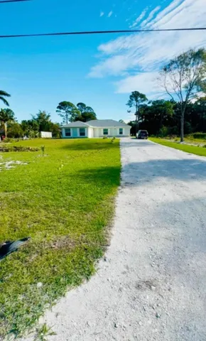 a view of yard with swimming pool and green space
