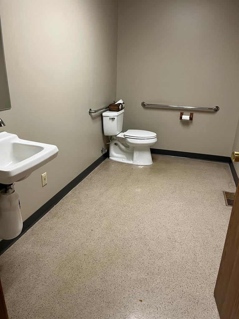 823 West Spring Street Titusville, PA 16354 - Photo 15 of 43 a white toilet sitting next to a white sink and vanity