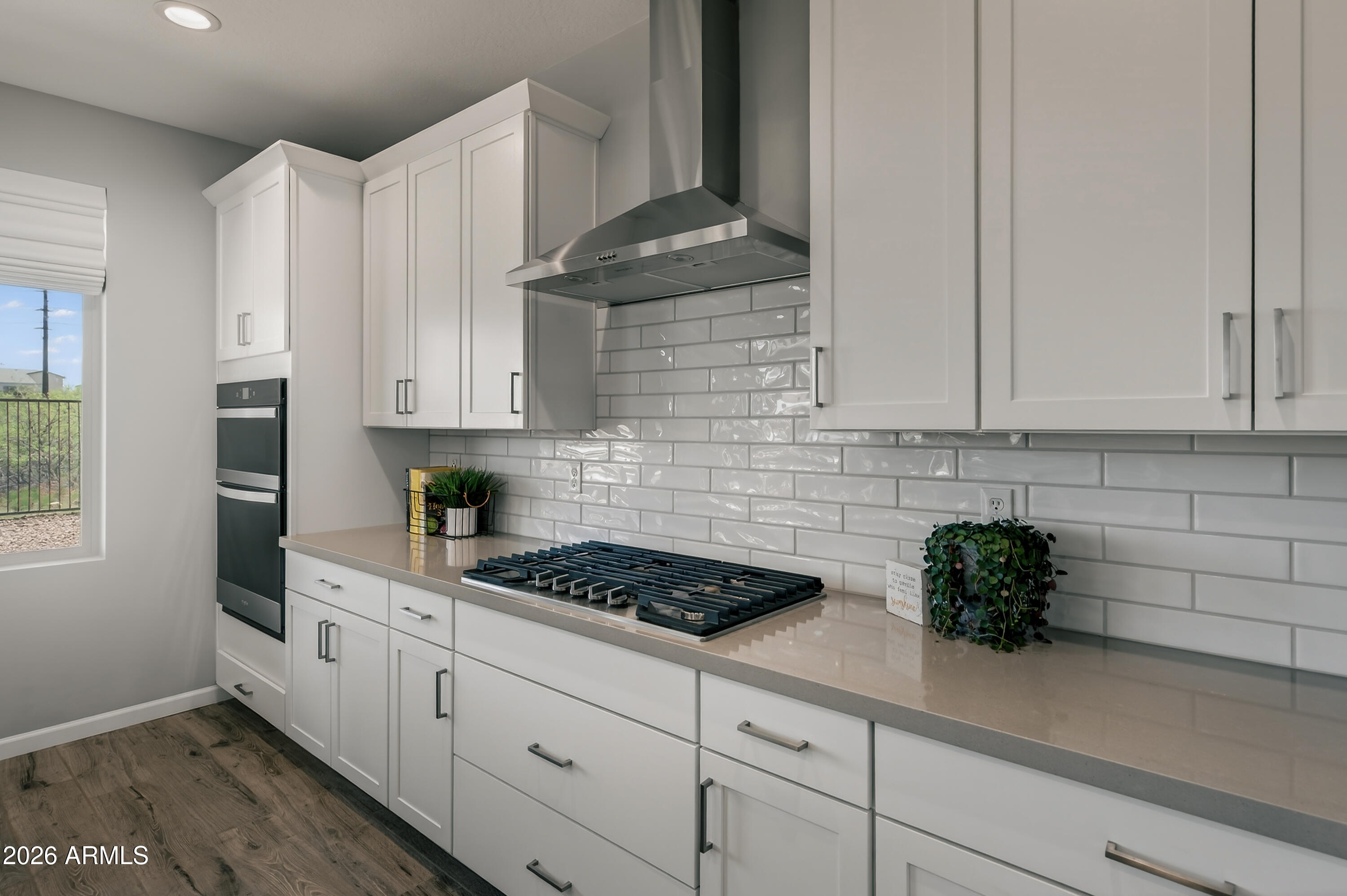 495 Cleopatra Hill Road Clarkdale, AZ 86324 - Photo 14 of 33 a kitchen with stainless steel appliances granite countertop white cabinets a stove a microwave and a window