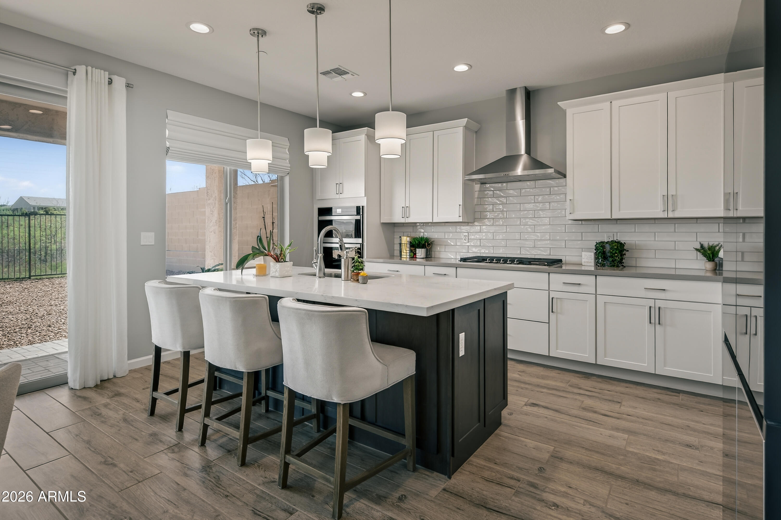 495 Cleopatra Hill Road Clarkdale, AZ 86324 - Photo 2 of 33 a kitchen with a dining table chairs sink and cabinets
