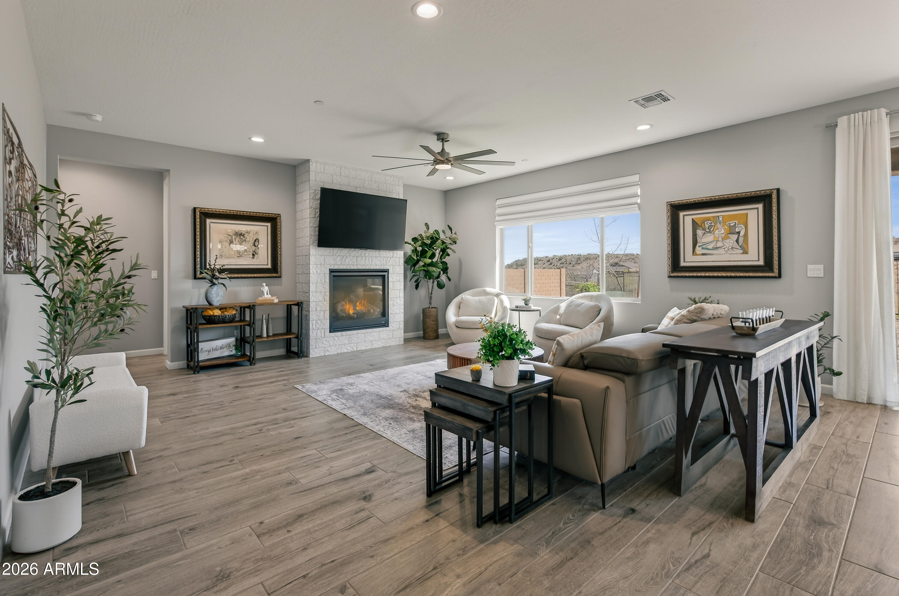 495 Cleopatra Hill Road Clarkdale, AZ 86324 - Photo 3 of 33 a living room with furniture flat screen tv and a fireplace