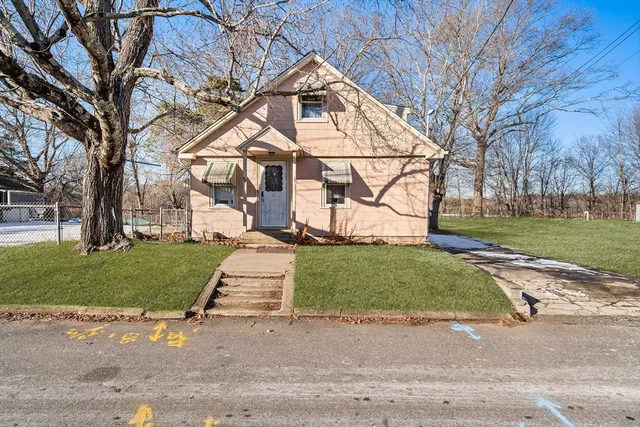 a white house with trees in the background