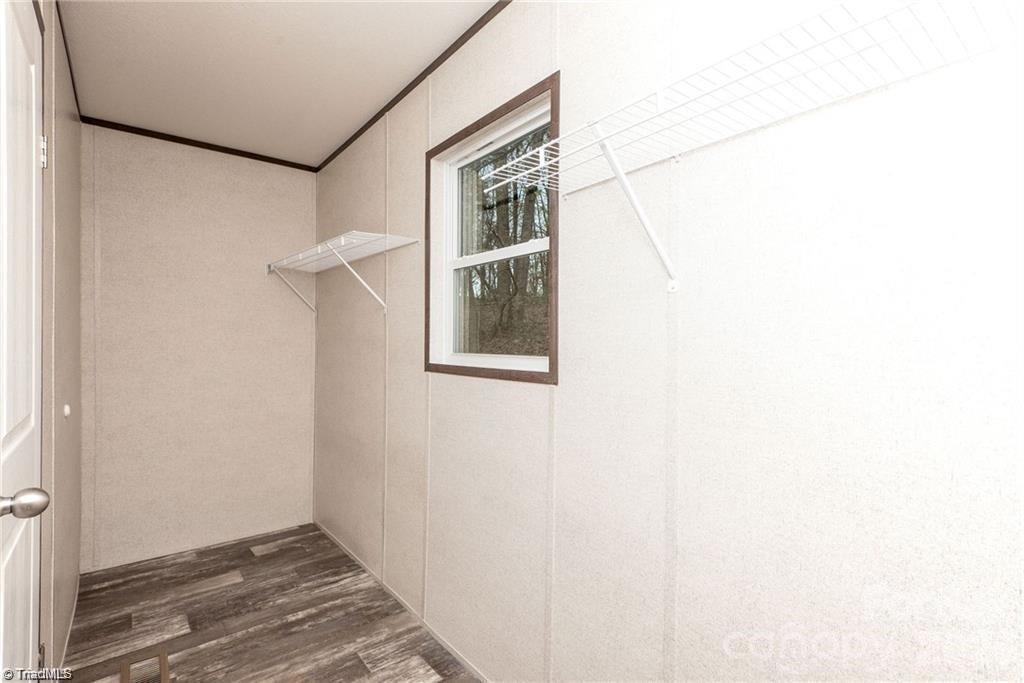 2013 Carl Fox Road Taylorsville, NC 28681 - Photo 18 of 22 a view of an empty room with wooden floor and a window