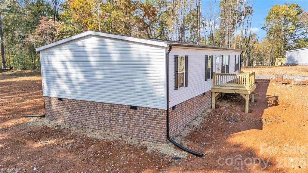 2013 Carl Fox Road Taylorsville, NC 28681 - Photo 3 of 22 a view of a house with a yard