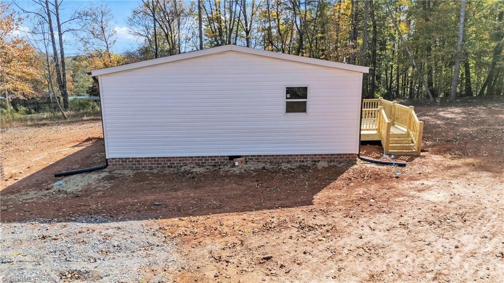 2013 Carl Fox Road Taylorsville, NC 28681 - Photo 4 of 22 a front view of a house with a yard