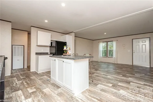 a view of kitchen with refrigerator stove microwave and cabinets