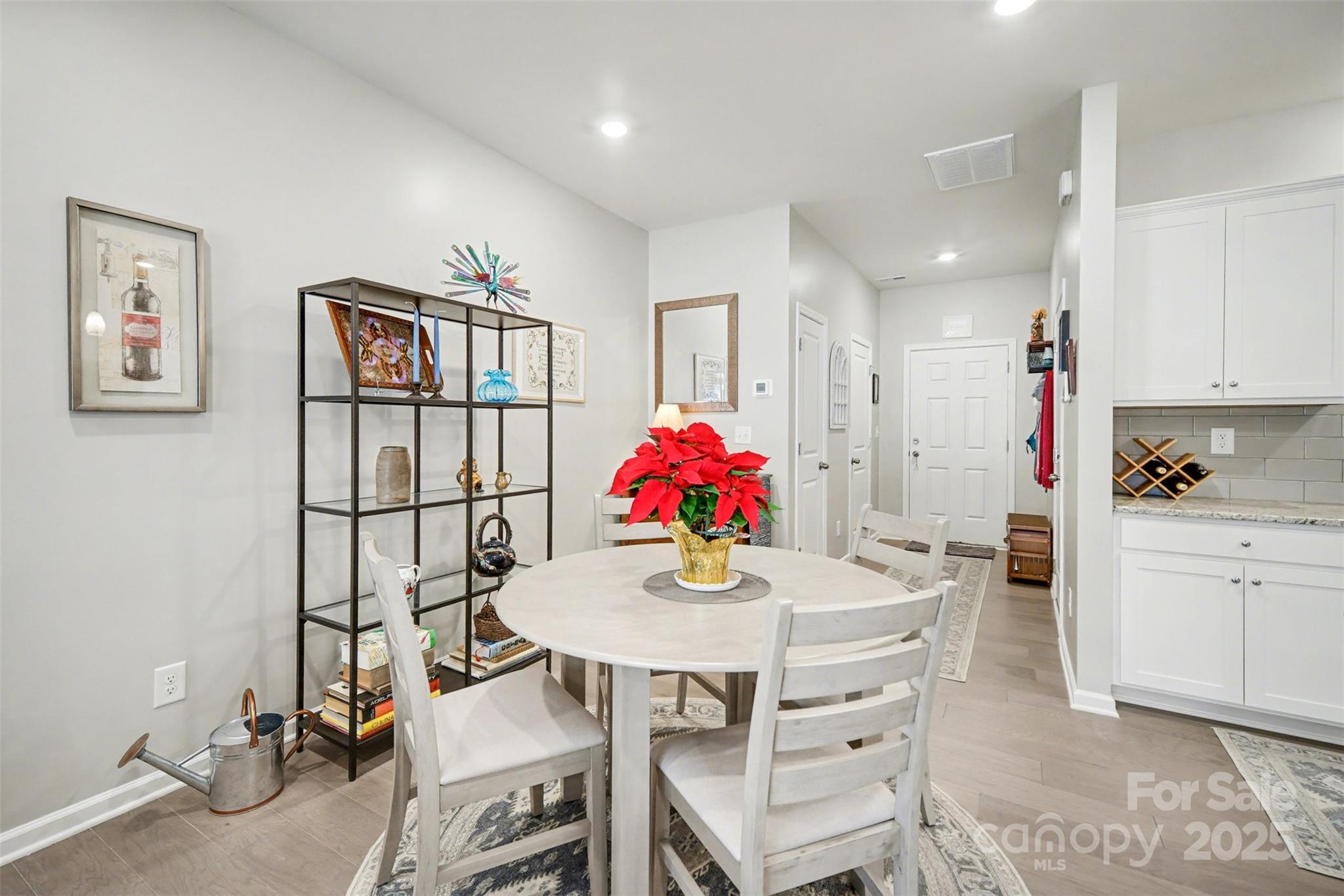 226 Quinn Road Matthews, NC 28104 - Photo 12 of 30 a view of kitchen island with furniture and wooden floor
