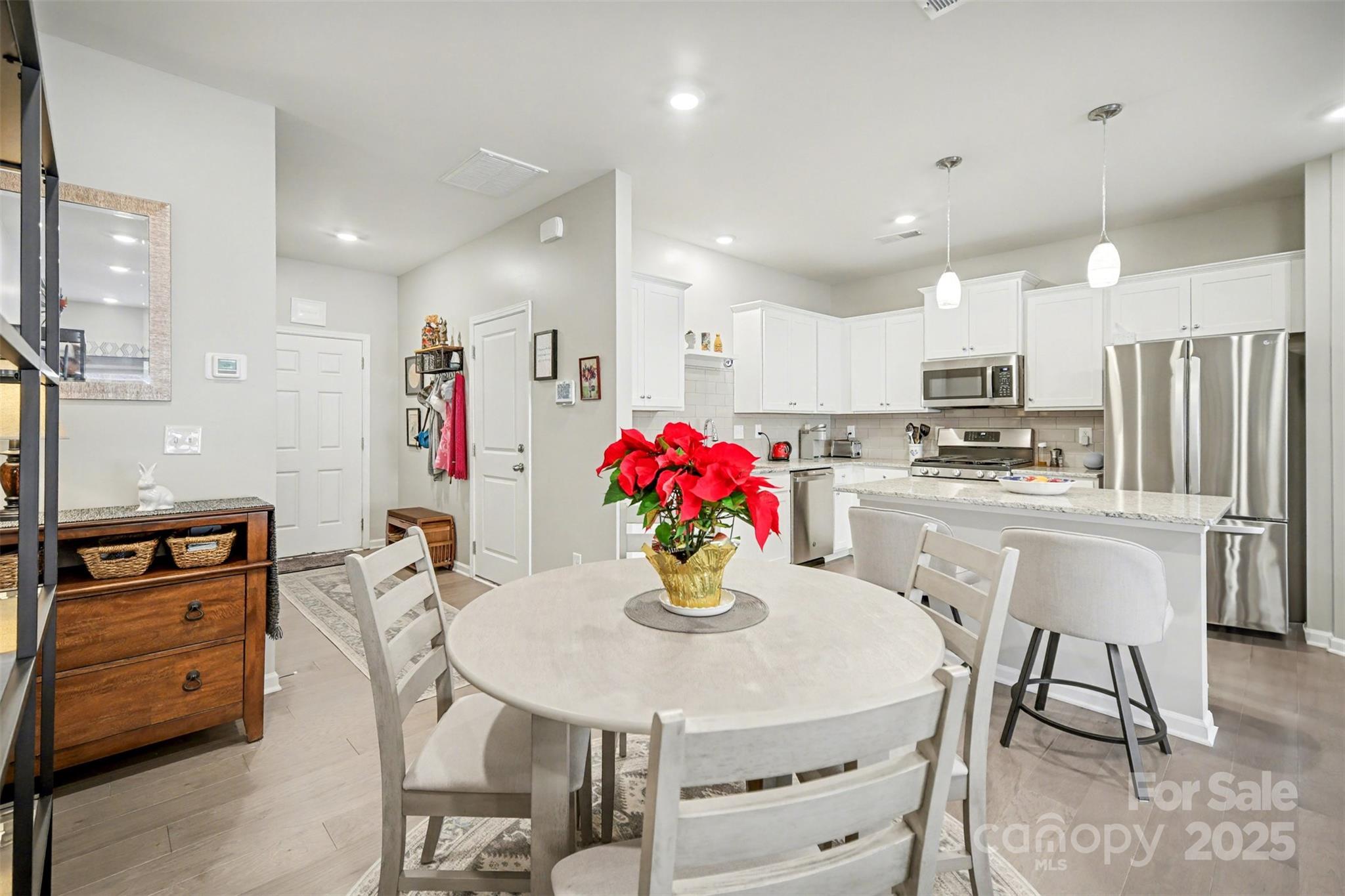 226 Quinn Road Matthews, NC 28104 - Photo 13 of 30 a kitchen with refrigerator a stove and a dining table