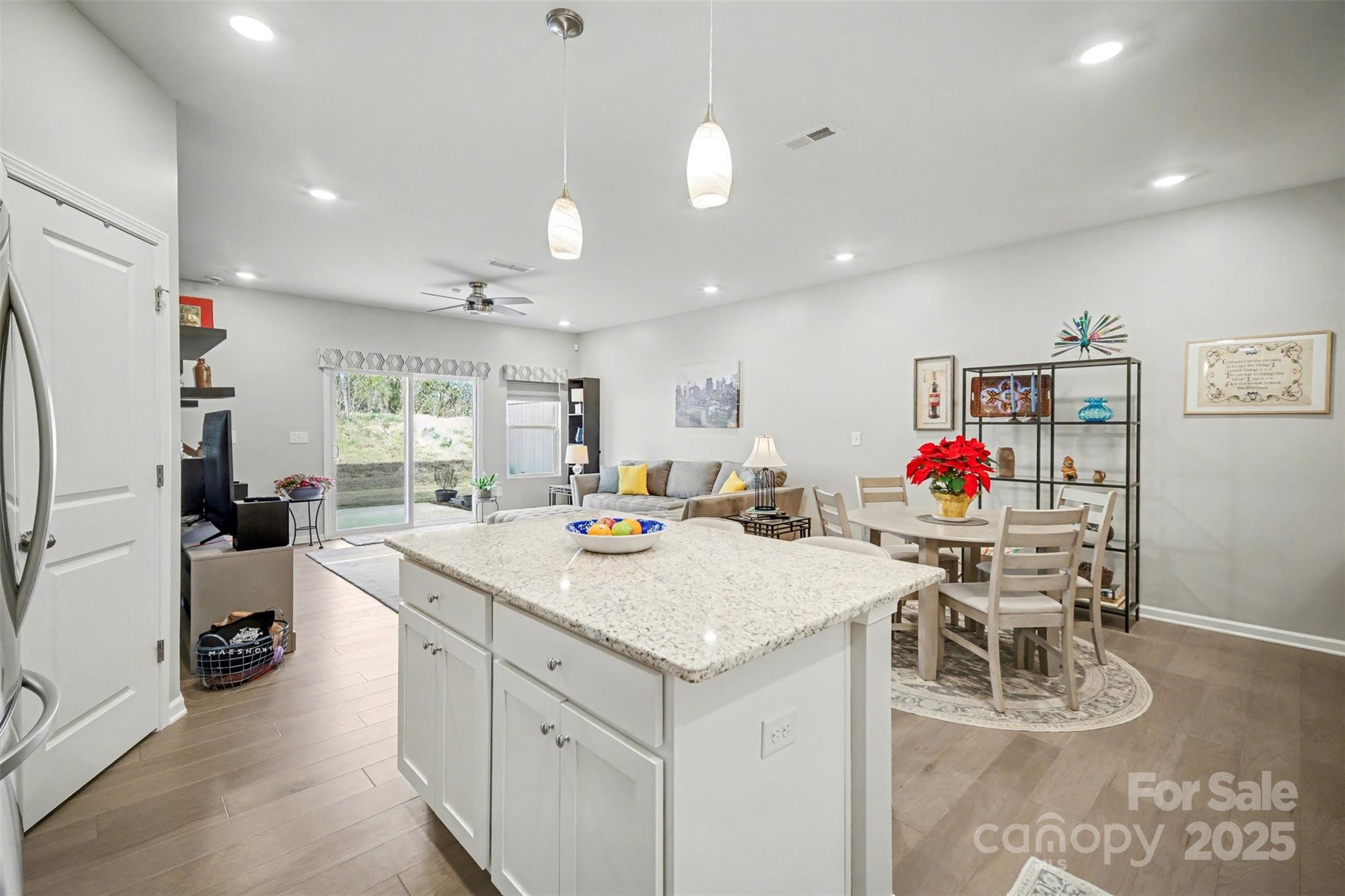 226 Quinn Road Matthews, NC 28104 - Photo 16 of 30 a view of kitchen island with stainless steel appliances granite countertop dining table chairs and white cabinets