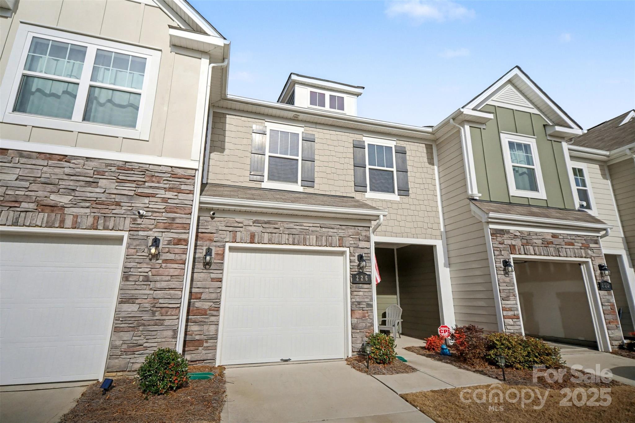 226 Quinn Road Matthews, NC 28104 - Photo 2 of 30 a front view of a house with a yard and garage