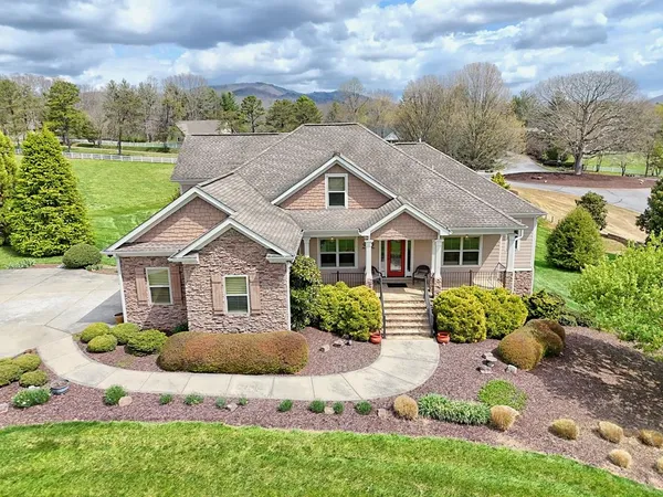 a front view of house with yard and green space