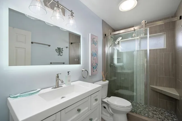 a bathroom with a sink toilet and shower