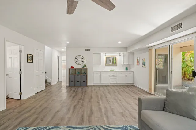 a living room with furniture and a kitchen
